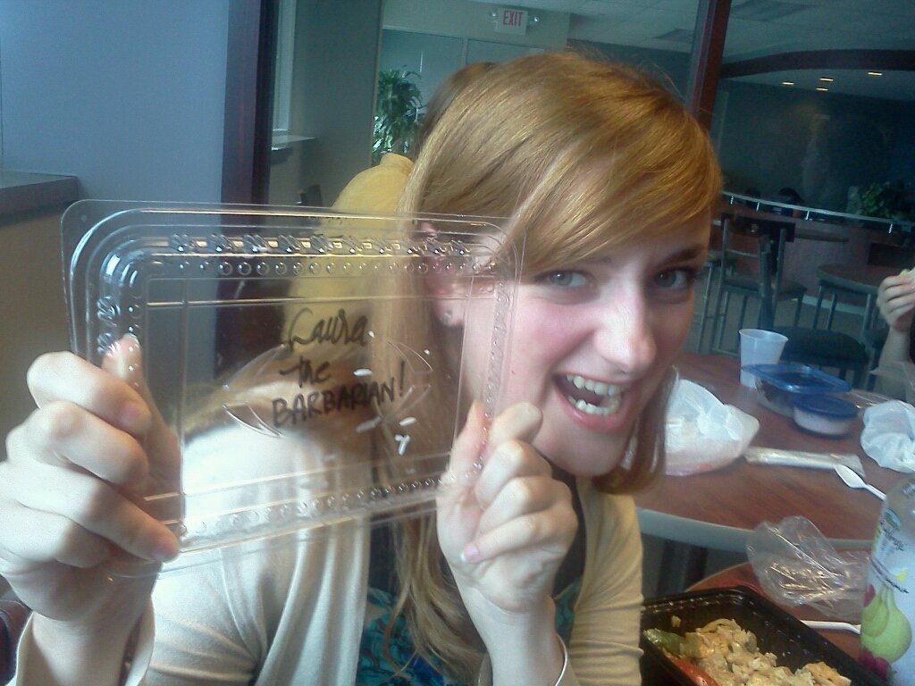 Laura holding her Thai Fusion 'Laura the BARBARIAN!' box.